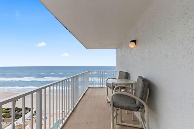 balcony with a beach view and a water view