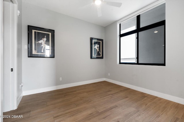 spare room with ceiling fan and wood-type flooring