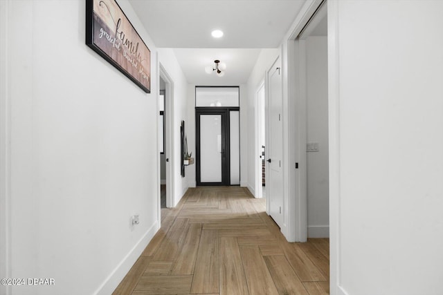 corridor with light parquet floors