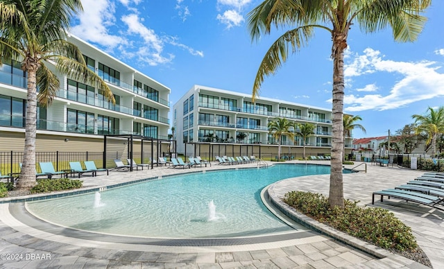 view of swimming pool featuring pool water feature and a patio