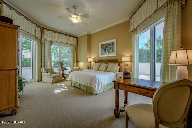 bedroom featuring access to exterior, light colored carpet, ornamental molding, and a ceiling fan