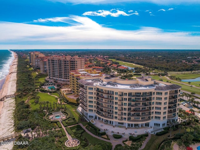 birds eye view of property with a view of the beach and a water view