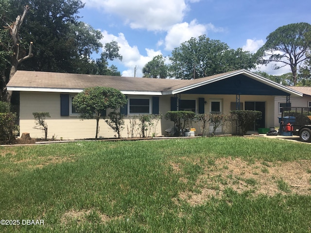 ranch-style home featuring a front yard