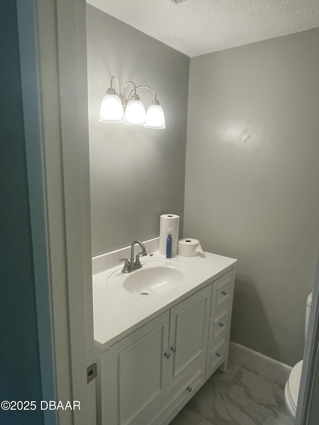 1500 Wildrose Ln, Daytona Beach, FL 32117 - half bathroom with vanity, a textured ceiling, and marble finish flooring