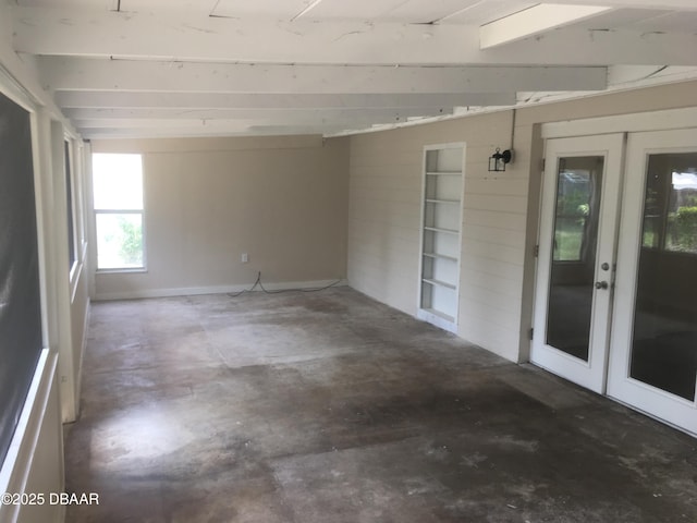 interior space with french doors and concrete floors