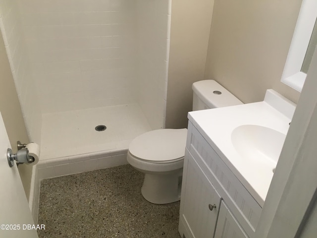 bathroom with toilet, vanity, and walk in shower