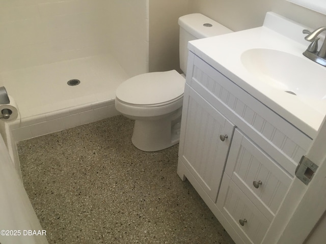 bathroom featuring vanity, toilet, and walk in shower