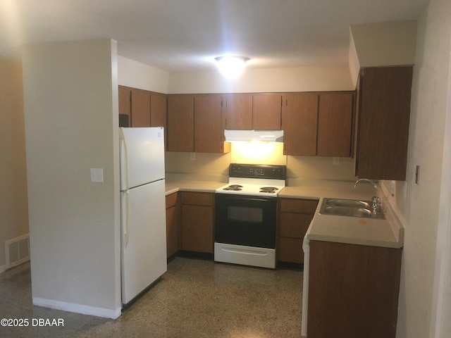 kitchen with electric stove, sink, and white fridge