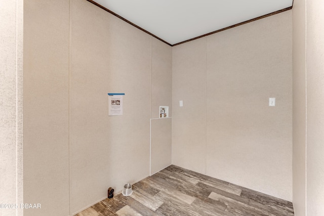 washroom featuring laundry area, hookup for a washing machine, wood finished floors, and ornamental molding