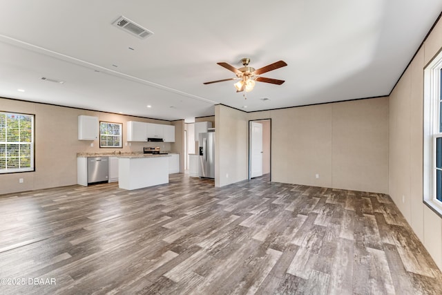 unfurnished living room featuring visible vents, recessed lighting, a ceiling fan, and wood finished floors