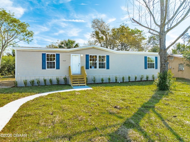 manufactured / mobile home with a front yard and entry steps