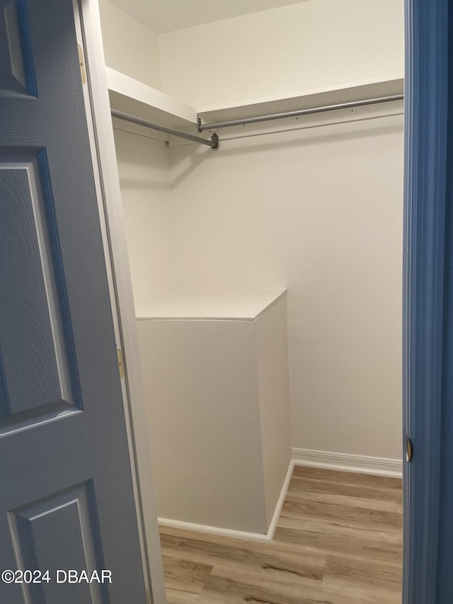 spacious closet featuring hardwood / wood-style floors