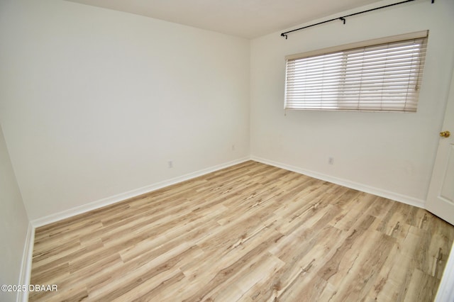 spare room featuring light wood-type flooring