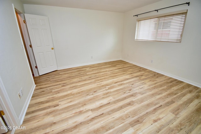 spare room with light hardwood / wood-style flooring