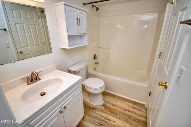 full bathroom with wood-type flooring, toilet, shower / bathing tub combination, and vanity