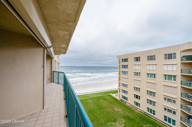 balcony with a beach view and a water view