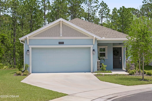 view of front of home featuring a garage and a front lawn