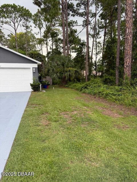 107 Beacon Mill Ln, Palm Coast, FL 32137 - view of green lawn featuring a garage