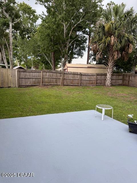 107 Beacon Mill Ln, Palm Coast, FL 32137 - fenced backyard featuring a patio area