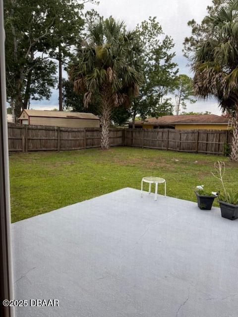 107 Beacon Mill Ln, Palm Coast, FL 32137 - fenced backyard with a patio
