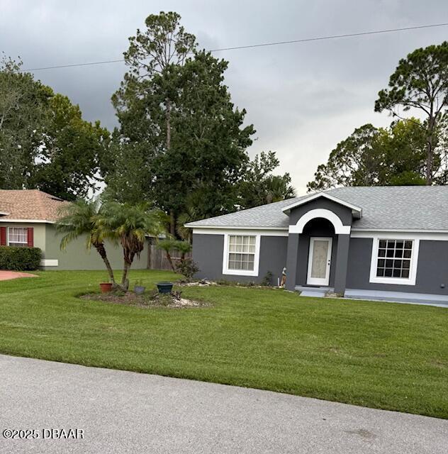 107 Beacon Mill Ln, Palm Coast, FL 32137 - ranch-style house with stucco siding and roof with shingles