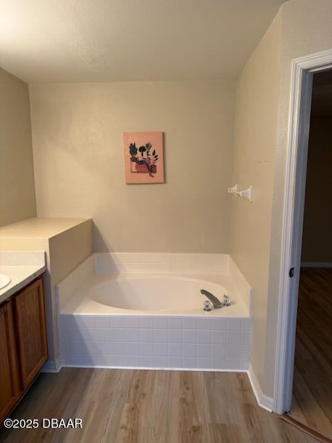 107 Beacon Mill Ln, Palm Coast, FL 32137 - full bath featuring a garden tub, vanity, and wood finished floors