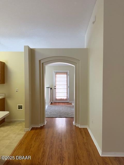 107 Beacon Mill Ln, Palm Coast, FL 32137 - corridor with light wood-type flooring and arched walkways