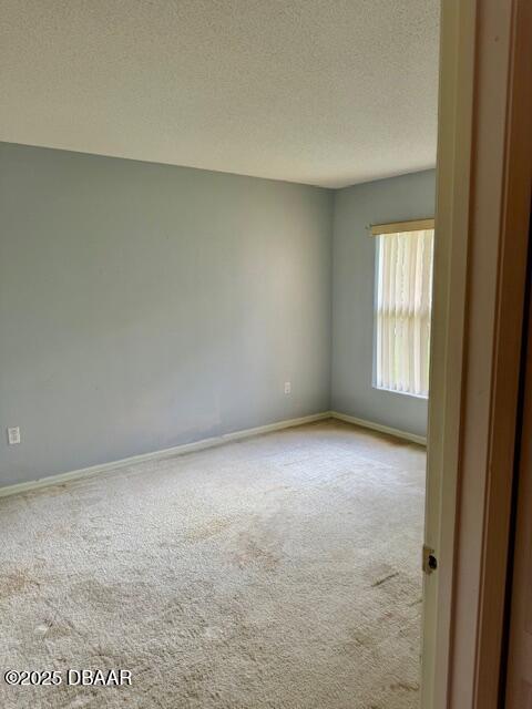 107 Beacon Mill Ln, Palm Coast, FL 32137 - unfurnished room featuring carpet flooring and a textured ceiling