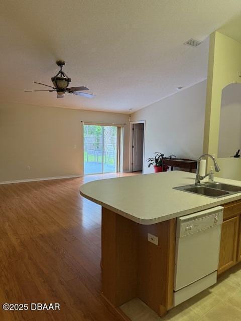 107 Beacon Mill Ln, Palm Coast, FL 32137 - kitchen featuring dishwasher, open floor plan, light countertops, light wood-style floors, and ceiling fan