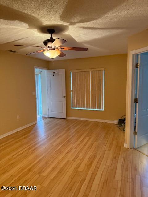 107 Beacon Mill Ln, Palm Coast, FL 32137 - empty room featuring ceiling fan, a textured ceiling, and light wood-type flooring