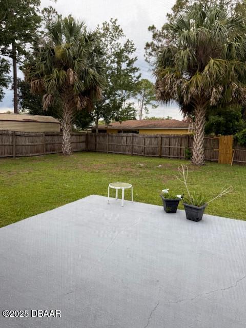 107 Beacon Mill Ln, Palm Coast, FL 32137 - fenced backyard with a patio