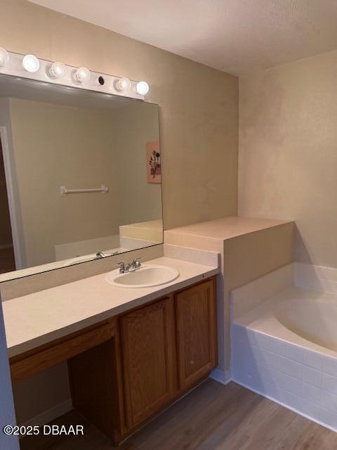 107 Beacon Mill Ln, Palm Coast, FL 32137 - full bathroom with a garden tub, vanity, and wood finished floors