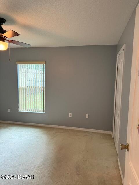 107 Beacon Mill Ln, Palm Coast, FL 32137 - unfurnished room with a ceiling fan, light colored carpet, and a textured ceiling