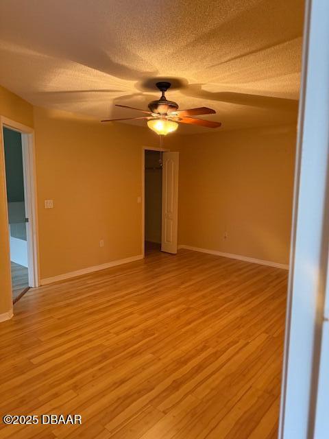 107 Beacon Mill Ln, Palm Coast, FL 32137 - empty room with ceiling fan, light wood-style floors, and a textured ceiling