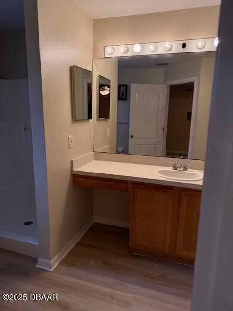 107 Beacon Mill Ln, Palm Coast, FL 32137 - bathroom with wood finished floors, vanity, and a walk in shower