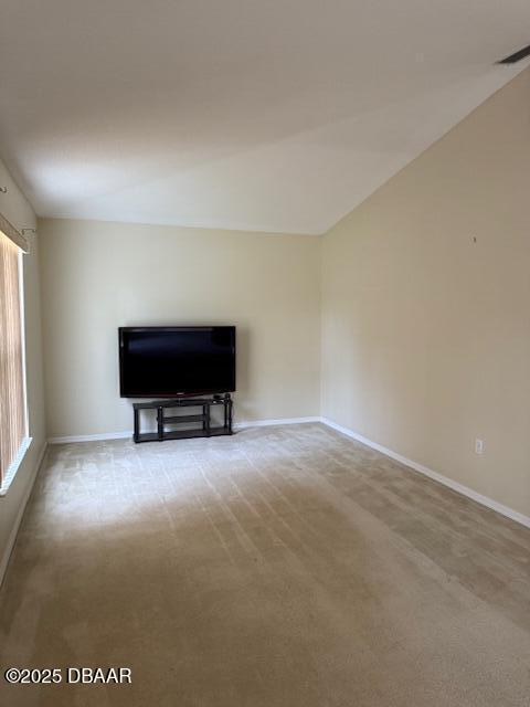107 Beacon Mill Ln, Palm Coast, FL 32137 - unfurnished living room featuring baseboards and carpet flooring