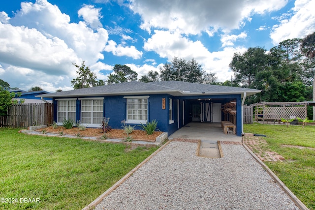 view of front of property with a front yard and a carport