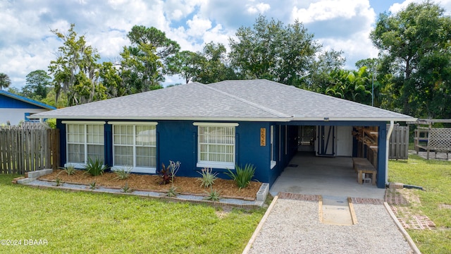 ranch-style home with a carport and a front yard