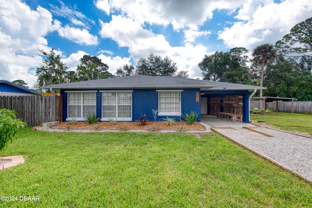 single story home with a front lawn and a carport