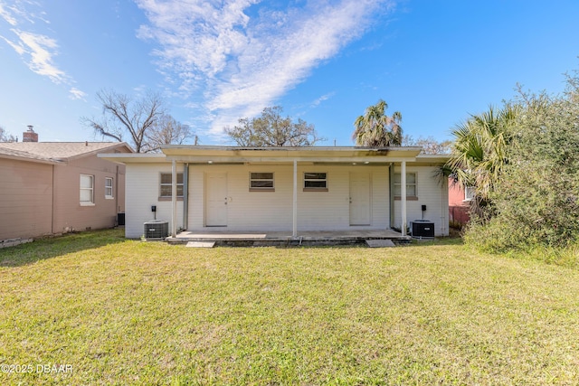 back of house featuring a patio area, central AC, and a lawn