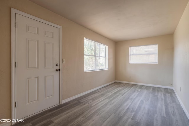 entrance foyer featuring wood finished floors and baseboards