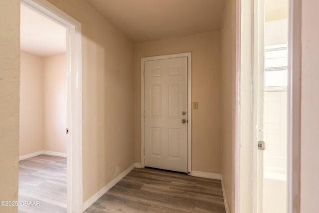 hall with wood finished floors and baseboards