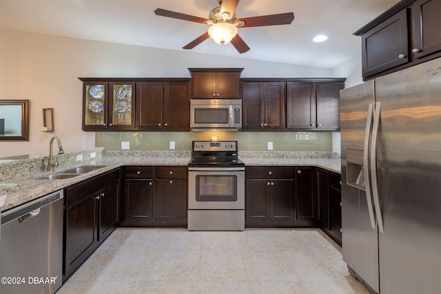 kitchen featuring sink, appliances with stainless steel finishes, tasteful backsplash, dark brown cabinets, and lofted ceiling