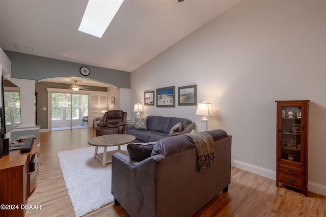 living room with ceiling fan, light hardwood / wood-style flooring, and high vaulted ceiling