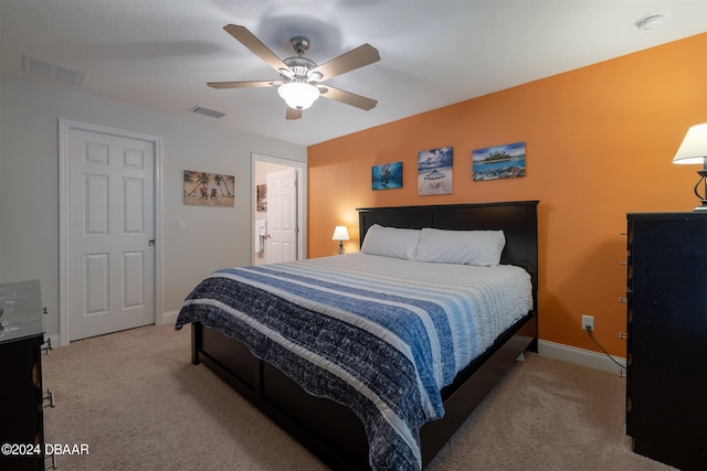 bedroom with light colored carpet and ceiling fan