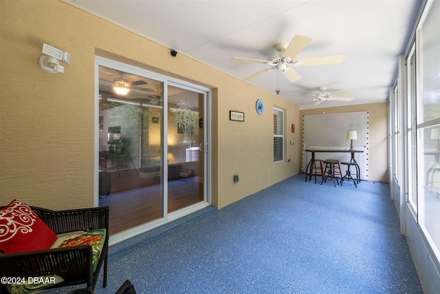 sunroom featuring ceiling fan