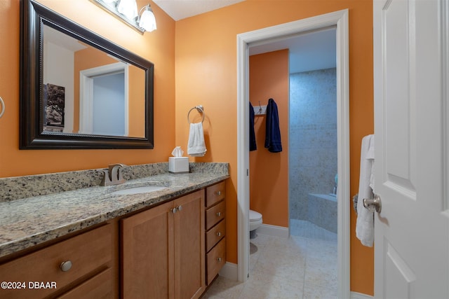 bathroom featuring toilet, vanity, and tile patterned floors