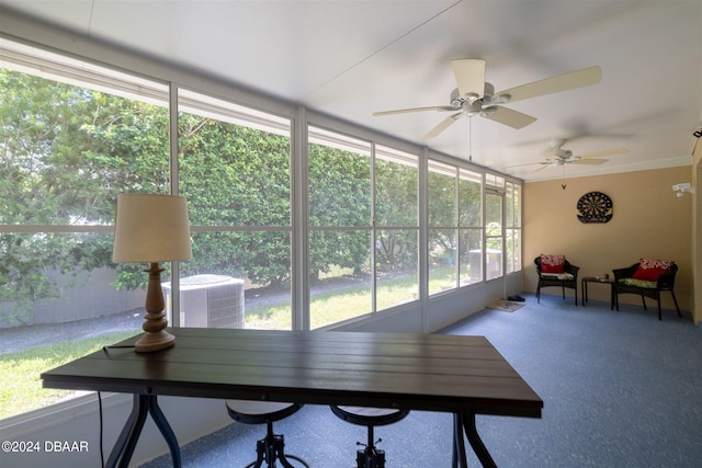 sunroom featuring ceiling fan