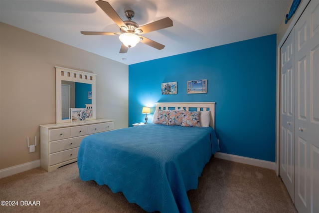 bedroom featuring ceiling fan, a closet, and light colored carpet