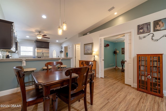 dining area featuring light hardwood / wood-style floors, ceiling fan, and vaulted ceiling